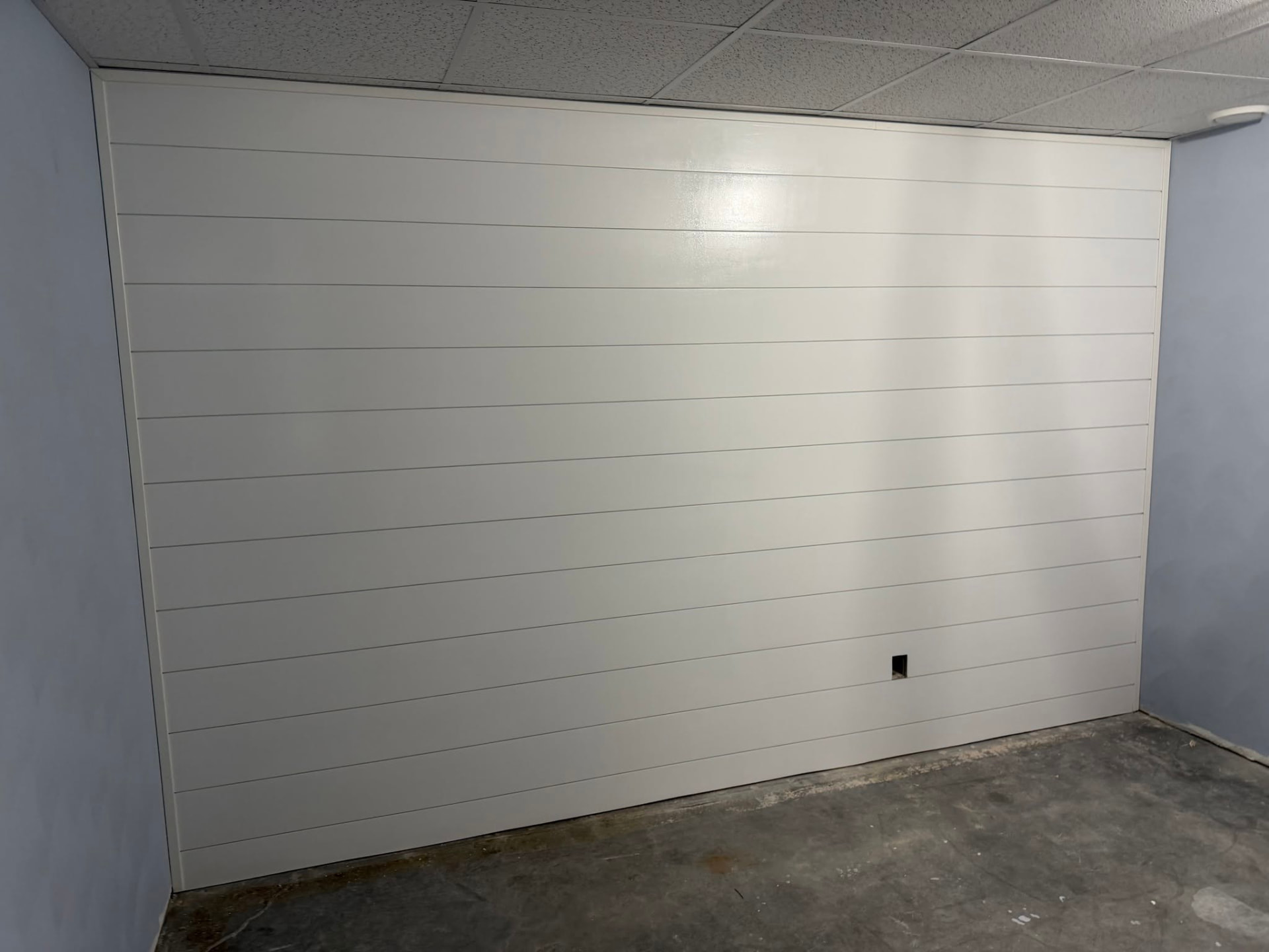White shiplap accent wall with horizontal boards