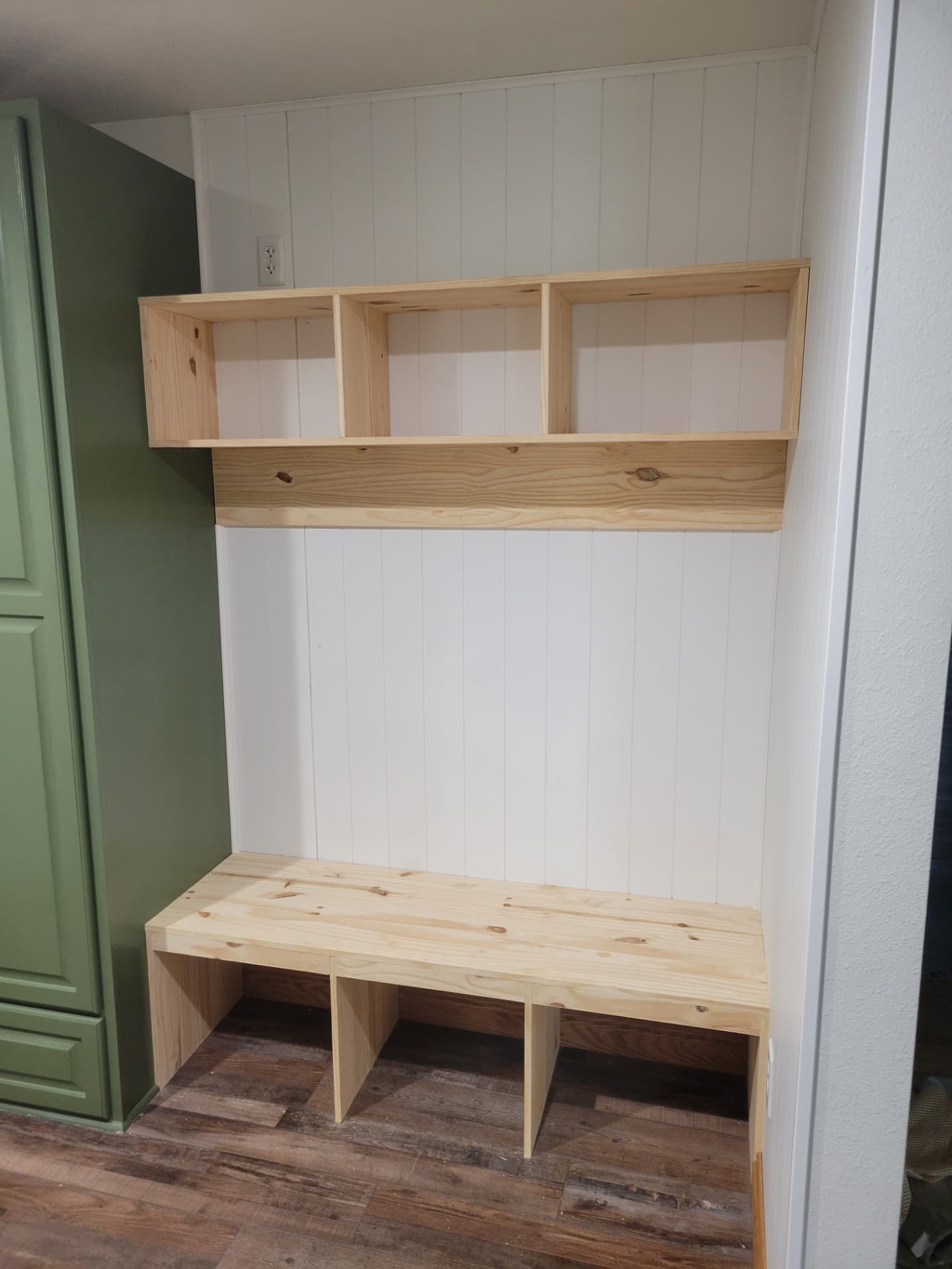 Custom built-in mudroom bench with upper shelving