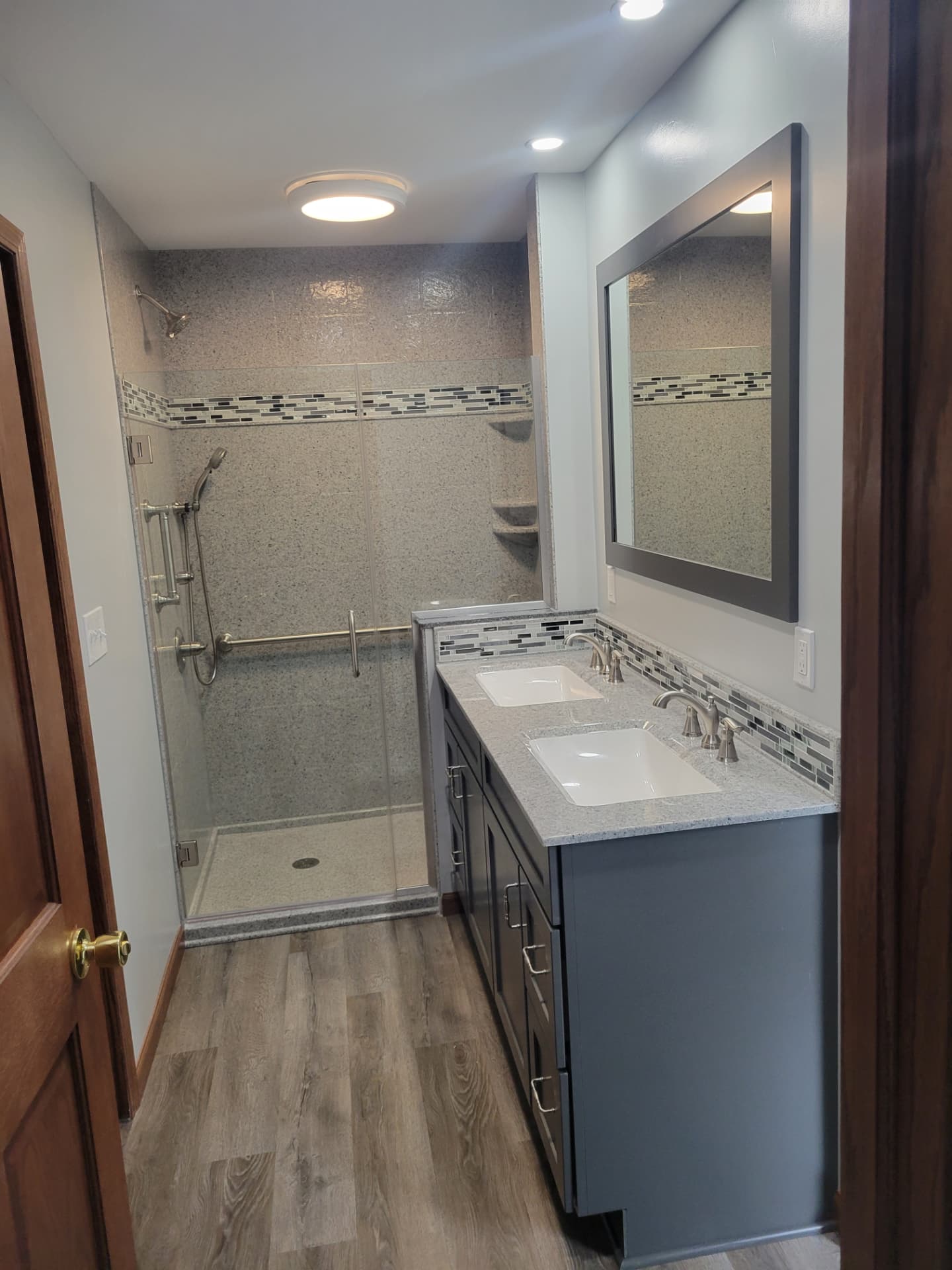 Remodeled bathroom with walk-in shower and double vanity